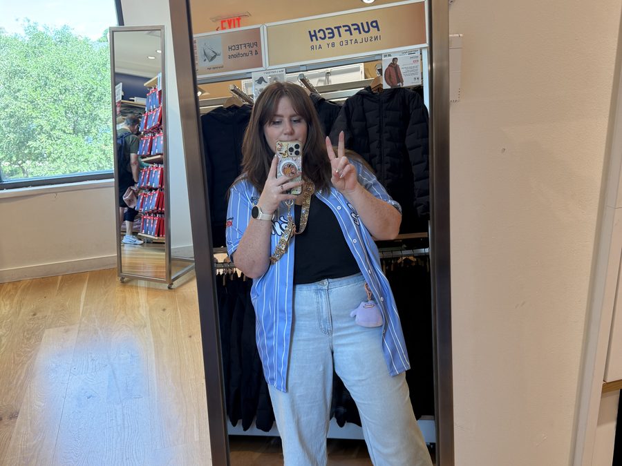 Bry taking a mirror selfie in a Pokémon jersey while out shopping